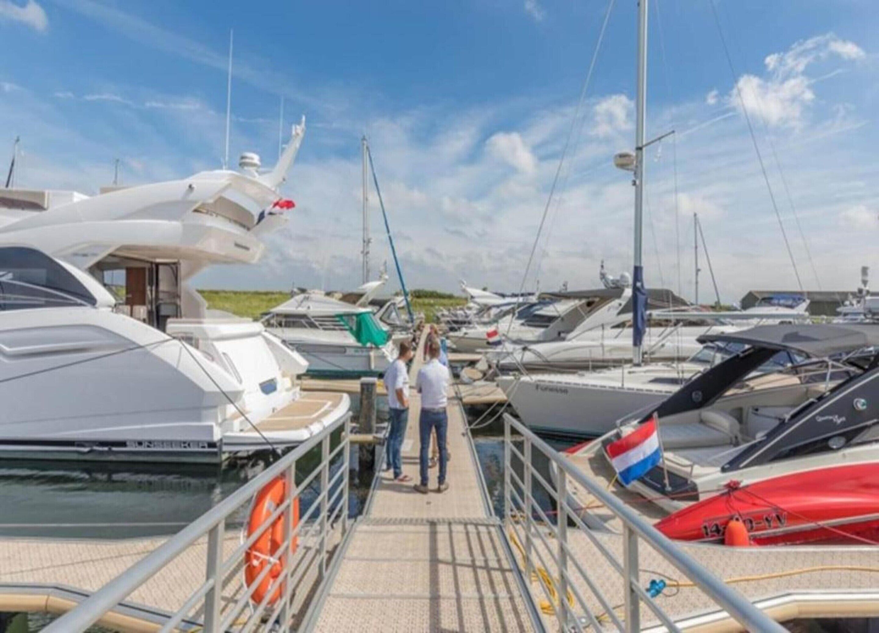 A marina with multiple yachts docked.