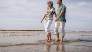 Two people standing in shallow water on a beach. - Special, Compound Group Accommodation, Near the Sea (Zandvoort)