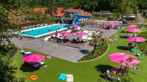 An outdoor swimming pool area with multiple pools, sun loungers, and umbrellas. - Cozy Lodge With a Dishwasher in the Achterhoek (Winterswijk - Brinkheurne)
