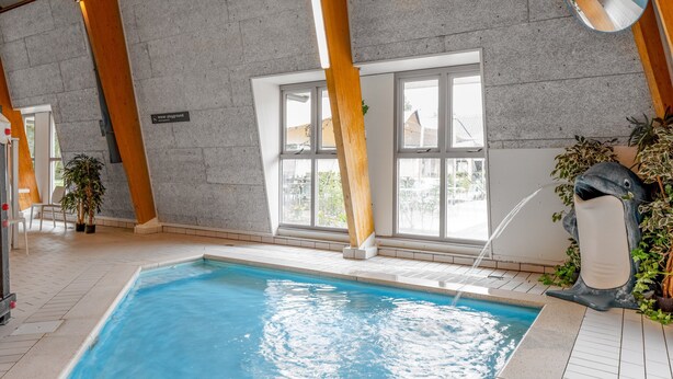 An indoor swimming pool with clear water, wooden beams, and large windows. - Forest Stay With Shared Pool (Borger)