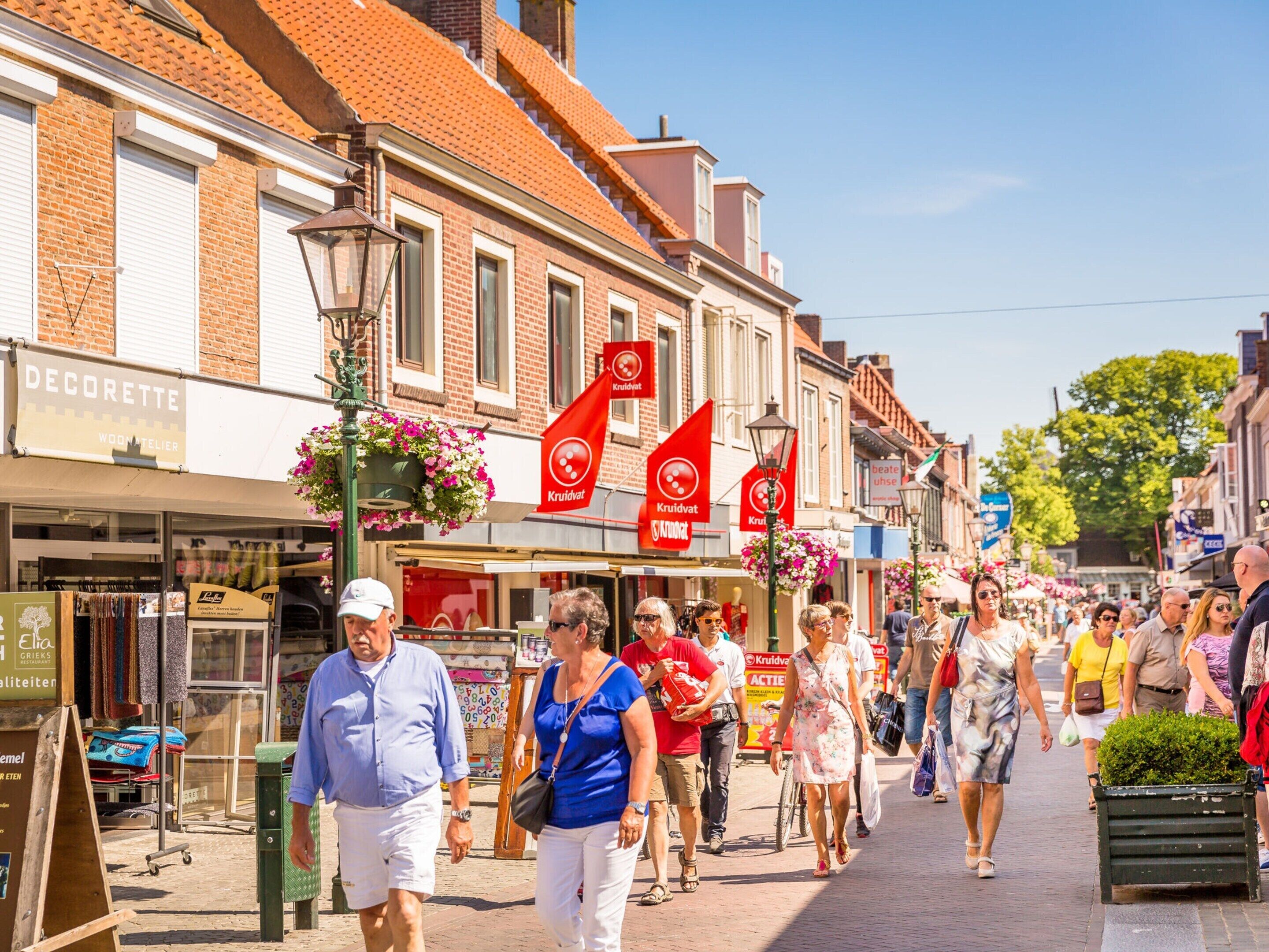 A busy street with shops and people walking.