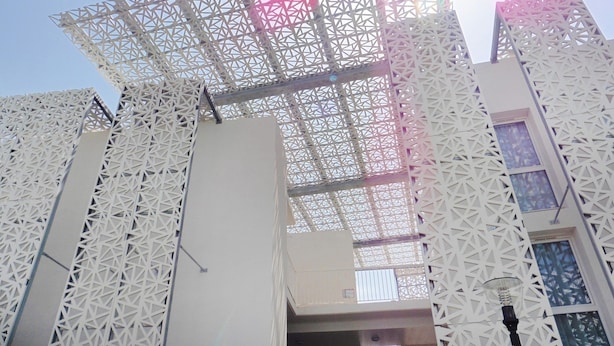 A building with a geometric facade and a large, open interior space. - Apartment in France With Furnished Terrace (Agde)