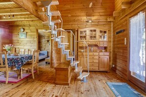 A wooden interior with a staircase, dining area, and kitchen. - Chalet With Garden in Lotharingen (Saint-Maurice-sur-Moselle)