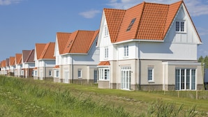 A row of modern houses with red-tiled roofs and white exteriors. - Villa in Cadzand-bad Near North Sea Coast (Cadzand-Bad)