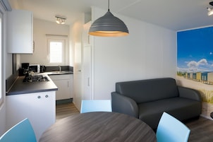 Eine moderne Küche mit Essbereich, einer Sitzecke und einem großen Fenster.