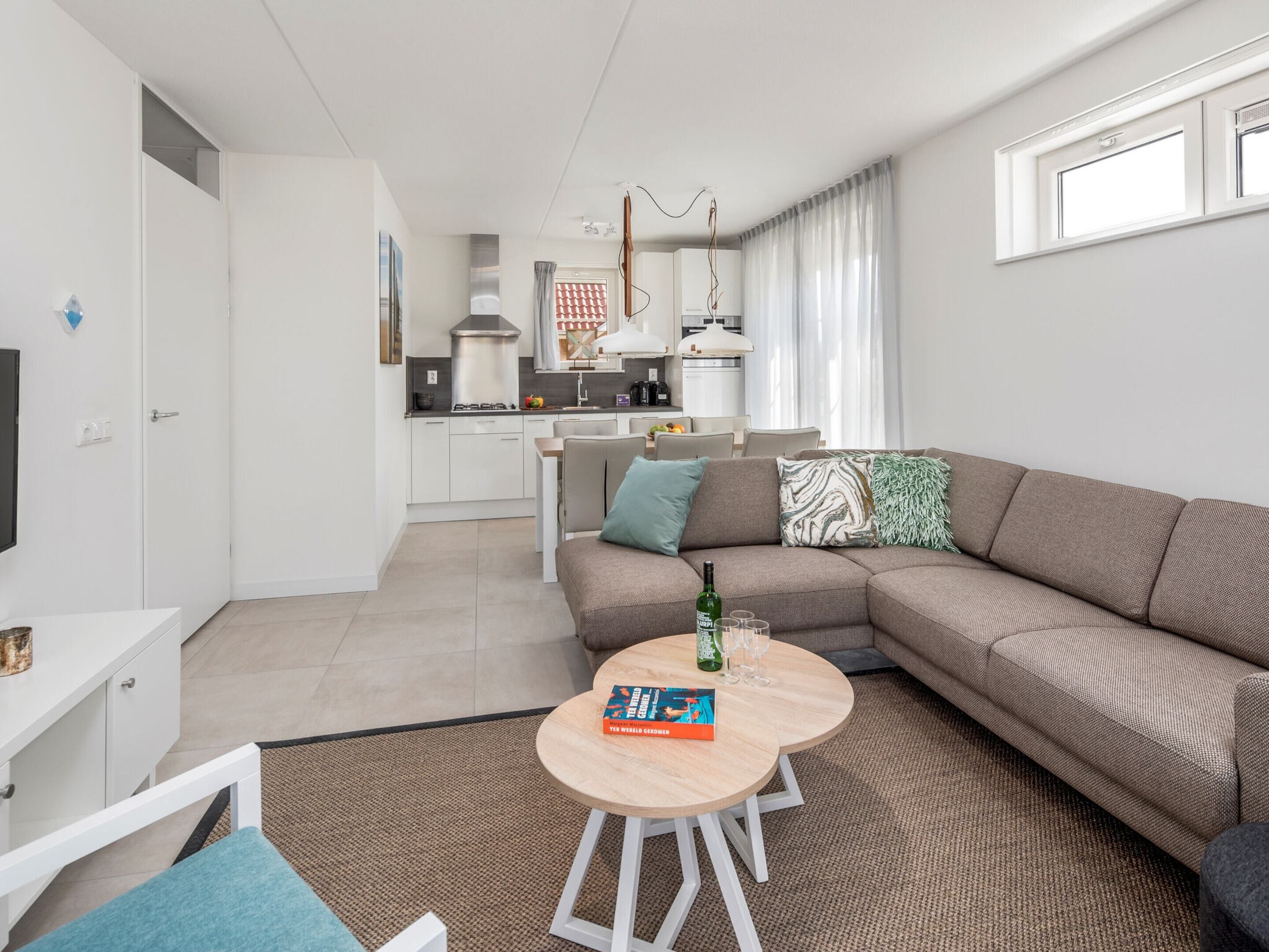 A modern living room with a sofa, a coffee table, and a TV.