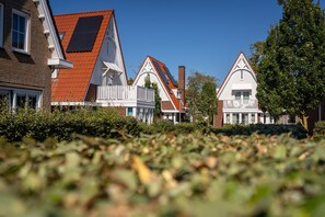 A row of traditional houses with pitched roofs and white trim.
