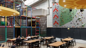 An indoor climbing area with colorful ropes and a climbing wall with various holds. - Detached Family Villa With Sauna (Weert)
