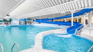 An indoor swimming pool with a blue water slide, a covered area with seating, and a restaurant named 'Terrazzo'. - Holiday Home in Kamperland Near the Beach (Kamperland)