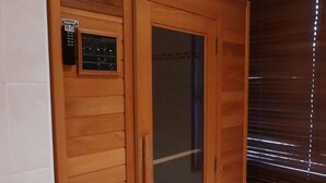 A wooden room with a control panel, a glass door, and a window with blinds. - Nice House with Dishwasher near Wadden Sea (Tzummarum)