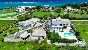An aerial view of a coastal property with multiple buildings, a swimming pool, and a view of the ocean. - 🌴 5 Bed Villa, Ocean View , Pool with Jacuzzi, Near Crane beach🌴 (Saint Philip)