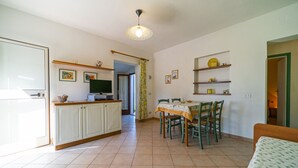 Un grand espace de vie comprenant une cuisine, une table à manger et un canapé.