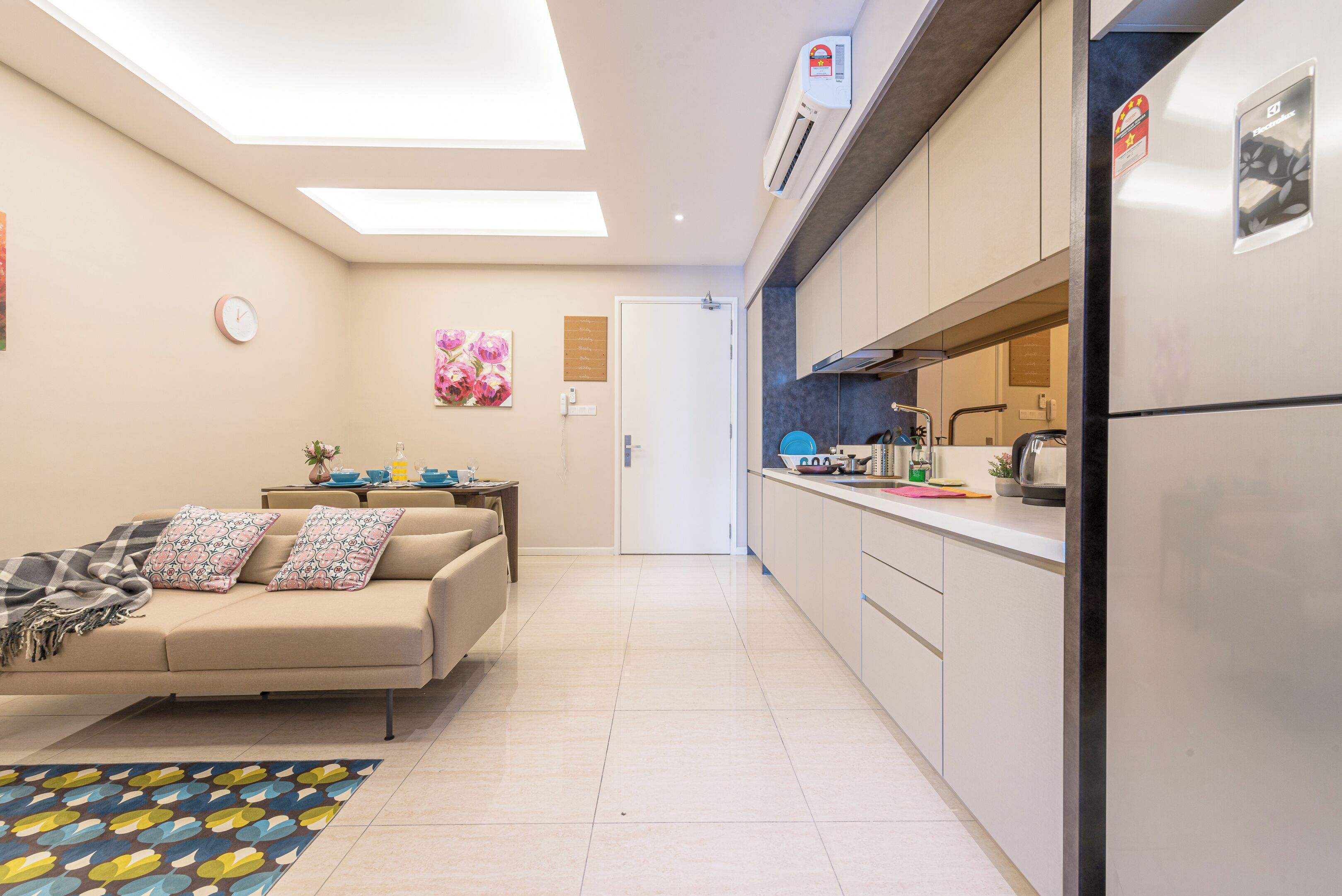 A modern kitchen with a refrigerator, stove, and microwave.