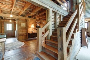Cozy living space with exposed beams, wooden floor, and a simple design.