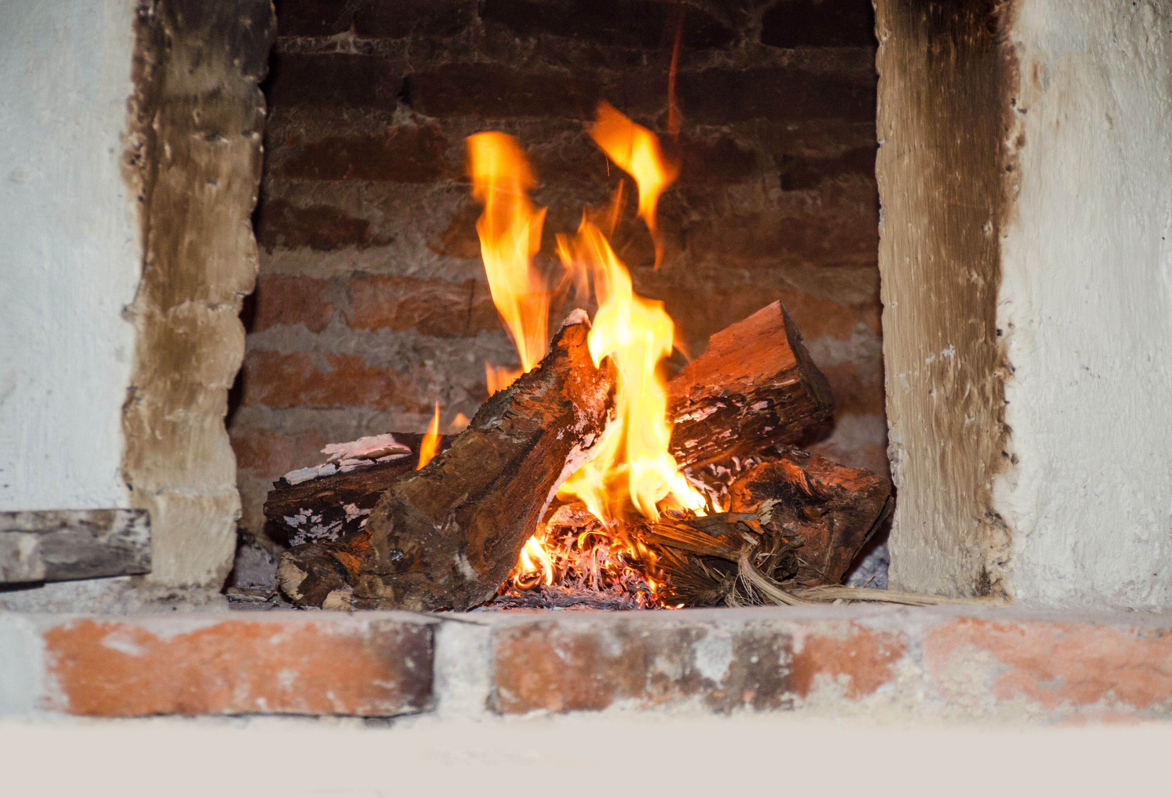 A fireplace with burning logs.