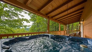 A hot tub under a wooden pergola with a view of trees. - Spectacular Mountain View! Hot Tub! Secluded! (Gatlinburg)