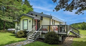 A single-story house with a front porch, a staircase leading to a deck, and a well-maintained lawn. - Renovated 4 Bed, 3 Bath. Mins from Port Sandfield. Tennis! Beach! (Minett)