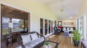 A spacious living area with a large window, a ceiling fan, and a dining area with a table and chairs. - Renovated 4 Bed, 3 Bath. Mins from Port Sandfield. Tennis! Beach! (Minett)