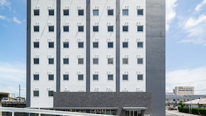A modern hotel building with a sign reading "SUPERHOTEL". - Super Hotel Kumamoto Yatsushiro (Yatsushiro)