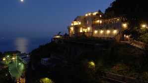 A coastal building with multiple balconies and a stone facade, overlooking the sea. - Villa Alba d' Oro - Historic Luxury Villa  (Amalfi)