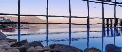 Seasonal outdoor pool, open 8:00 AM to 6:30 PM, pool umbrellas