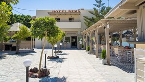 A hotel named "HOTEL RENA" with a reception area, outdoor seating, and a paved courtyard. - Rena Hotel (Santorini)