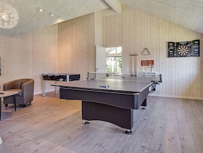 A room with a ping pong table, a foosball table, and a dartboard. - Holiday Home in Kappeln (Kappeln)