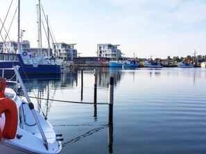A marina with boats docked, calm water, and a clear sky. - Holiday Home in Wendtorf (Wendtorf)