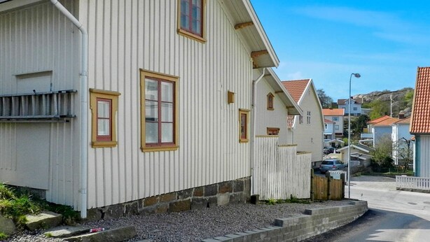 A white building with a steep roof and a chimney. - 6 Person Holiday Home in Lysekil (Lysekil)