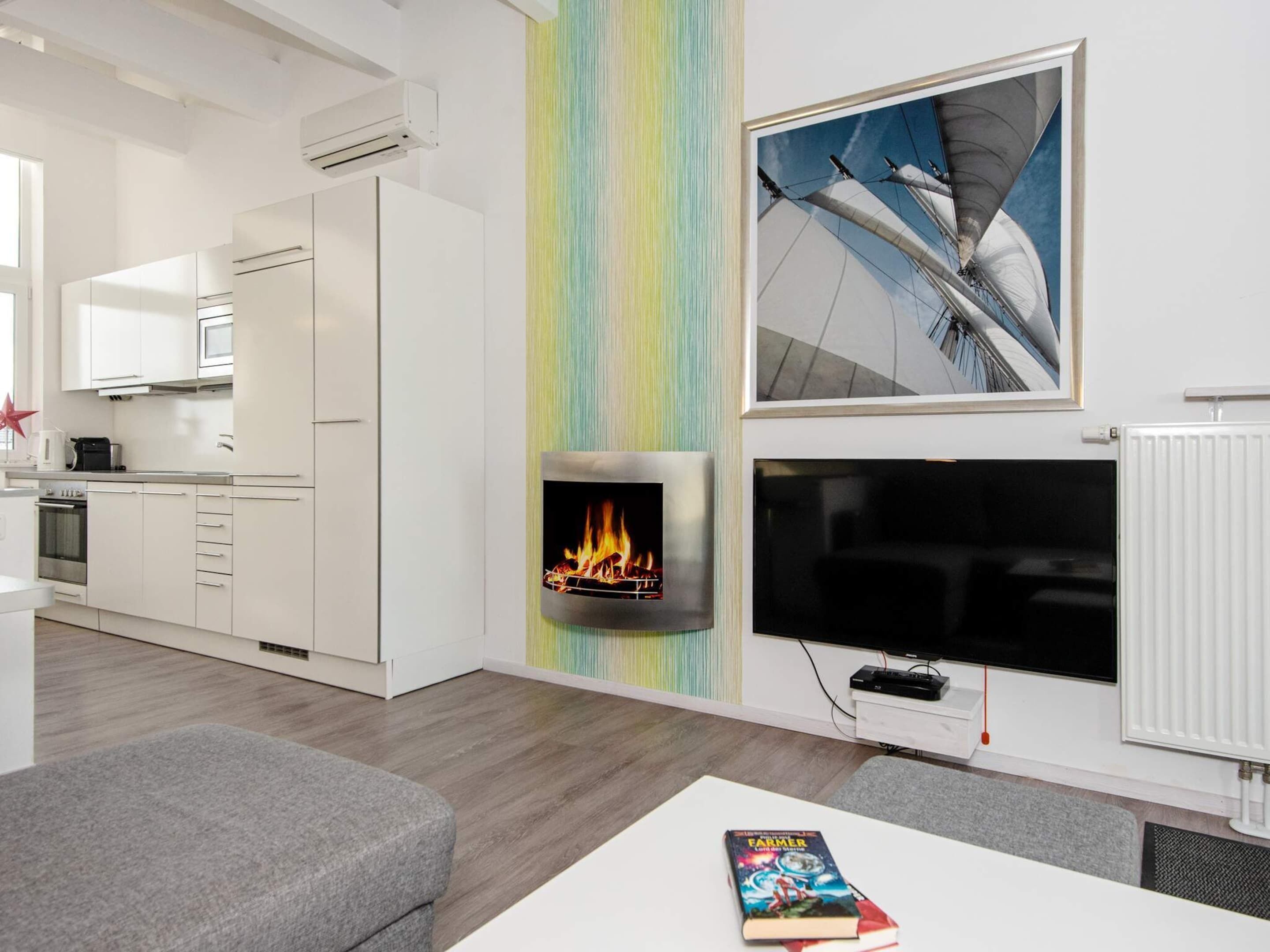 A modern kitchen with white cabinets, a microwave, and an oven.