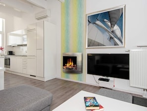 A modern kitchen with white cabinets, a microwave, and an oven. - Holiday Home in Wendtorf (Wendtorf)