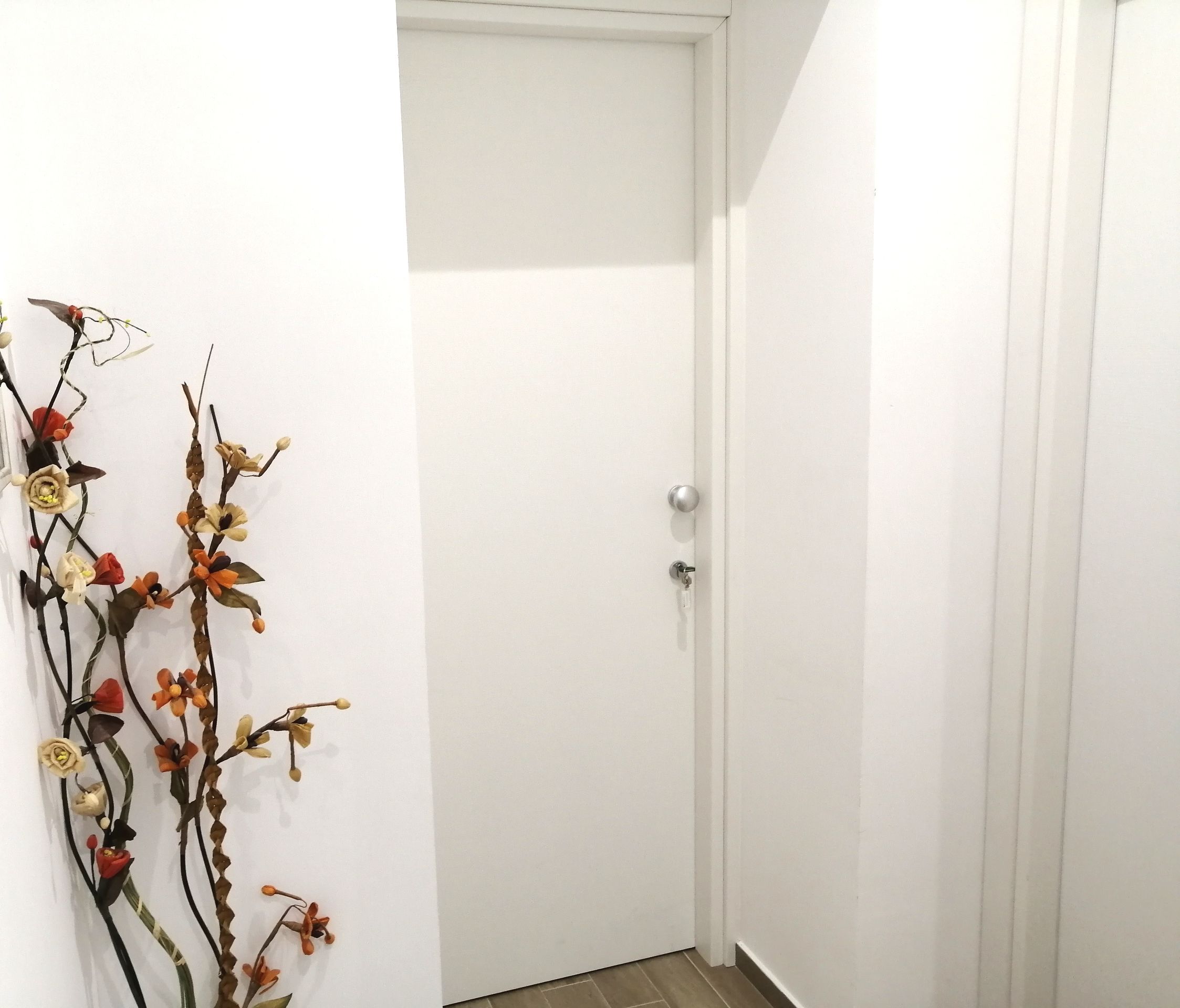 A white door with a keyhole and a door handle.