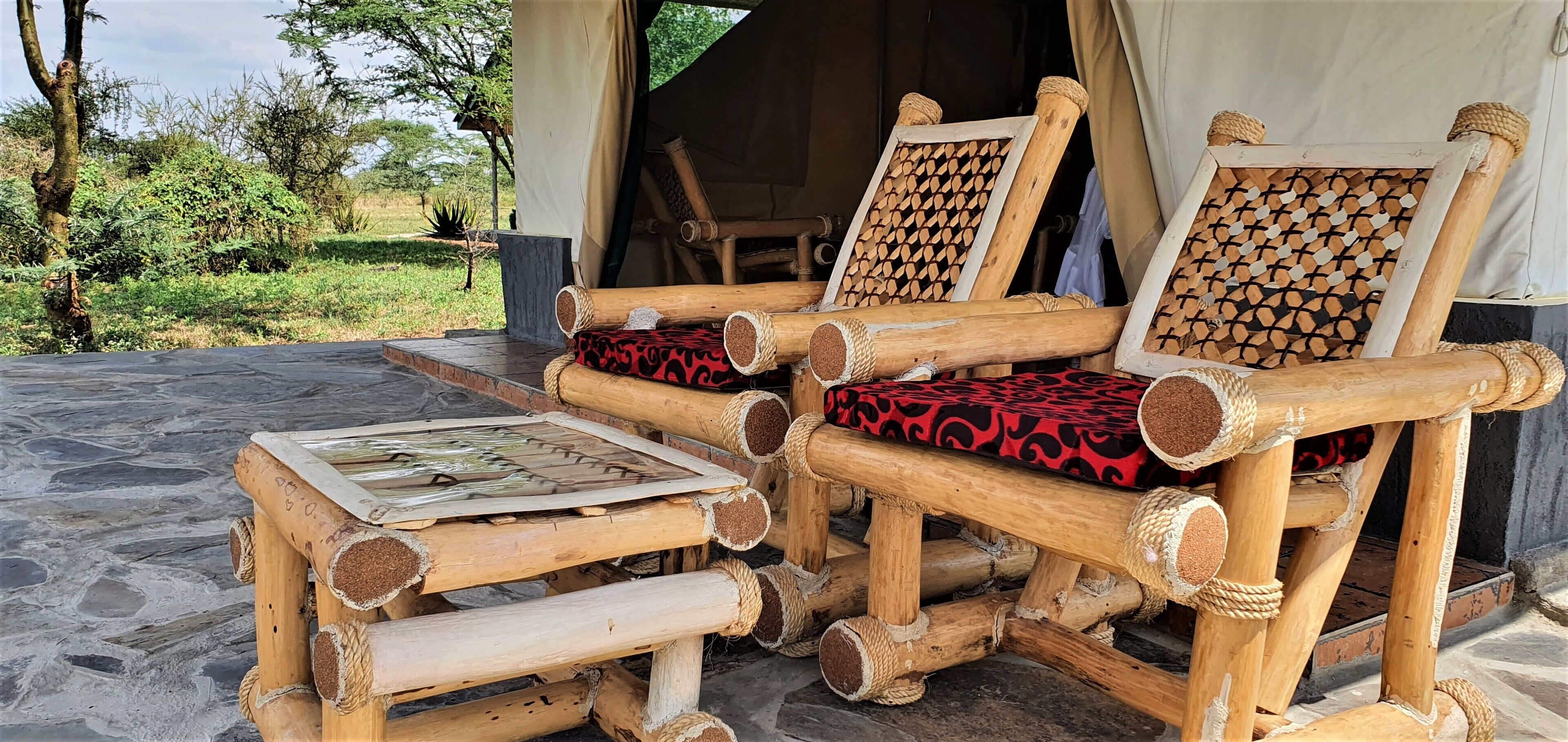 A rustic wooden chair with a woven backrest and a matching cushion, placed on a stone floor.