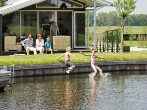 A swimming pool with a house in the background.