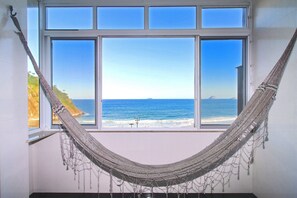 A hammock tied to a window with a view of the ocean. - Rio Spot D047 (Rio de Janeiro)