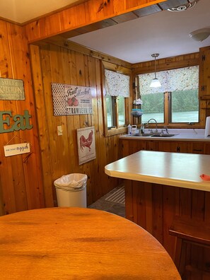 Enjoy cooking in this kitchen with a sink, light fixture, and window offering a view of the outdoors.