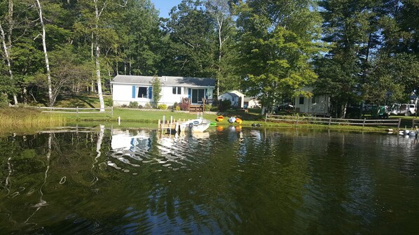 Enjoy a serene lakeside retreat with a dock and expansive porch.