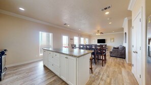 Enjoy a comfortable living area with a kitchen, dining space, and large windows.