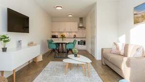 A compact living space with a kitchenette, dining area, and seating area. - Apartment in Zoutelande Near the Beach (Zoutelande)