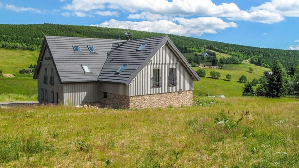 A single-story house with a sloped roof, a stone foundation, and multiple windows. - Na Pomezkách by Interhome (Malá Úpa)