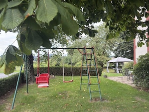 A playground with swings and a climbing structure.