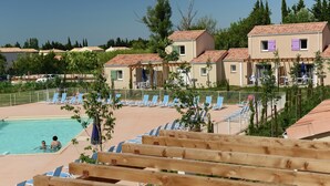 A pool area with lounge chairs and a swimming pool. - Apartment in Le Paradou With Pool & Sauna (Paradou)