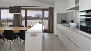 Private kitchen - Lush Villa With a Terrace in Nature Reserve (Ouddorp)