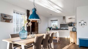 A modern kitchen with white cabinets, a wooden countertop, and a blue pendant light. - Holiday Home With Private Jetty on Water (Akkrum)