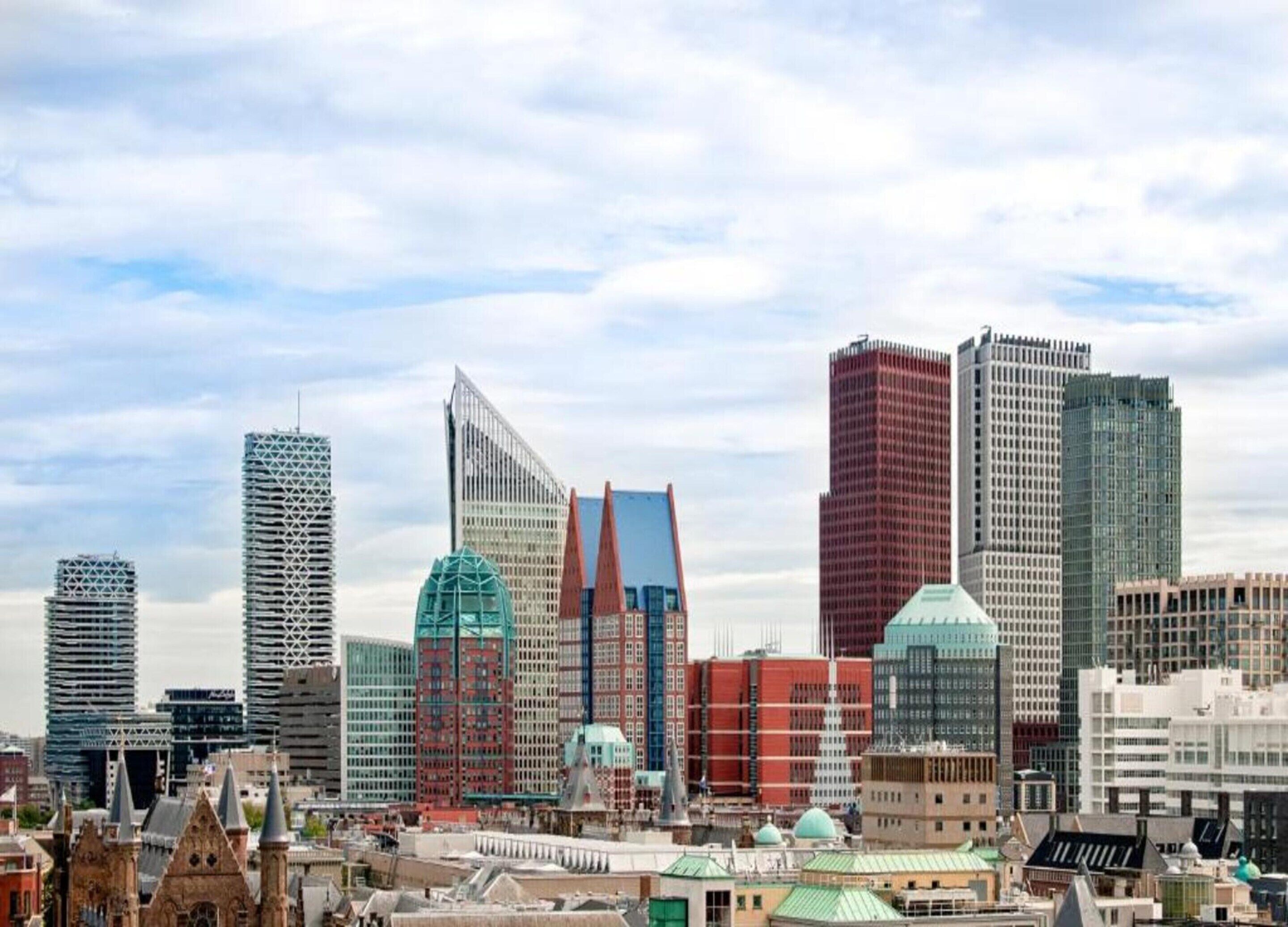 A cityscape with modern high-rise buildings and historic architecture.