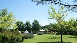 A well-maintained garden with a grassy lawn, several trees, and a gazebo. - Holiday Home in Montone With Swimming Pool (Montone)