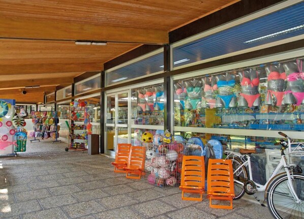 A store with a variety of colorful items on display, including toys and accessories. - Modern Chalet w/ Pool Views (Cellole)