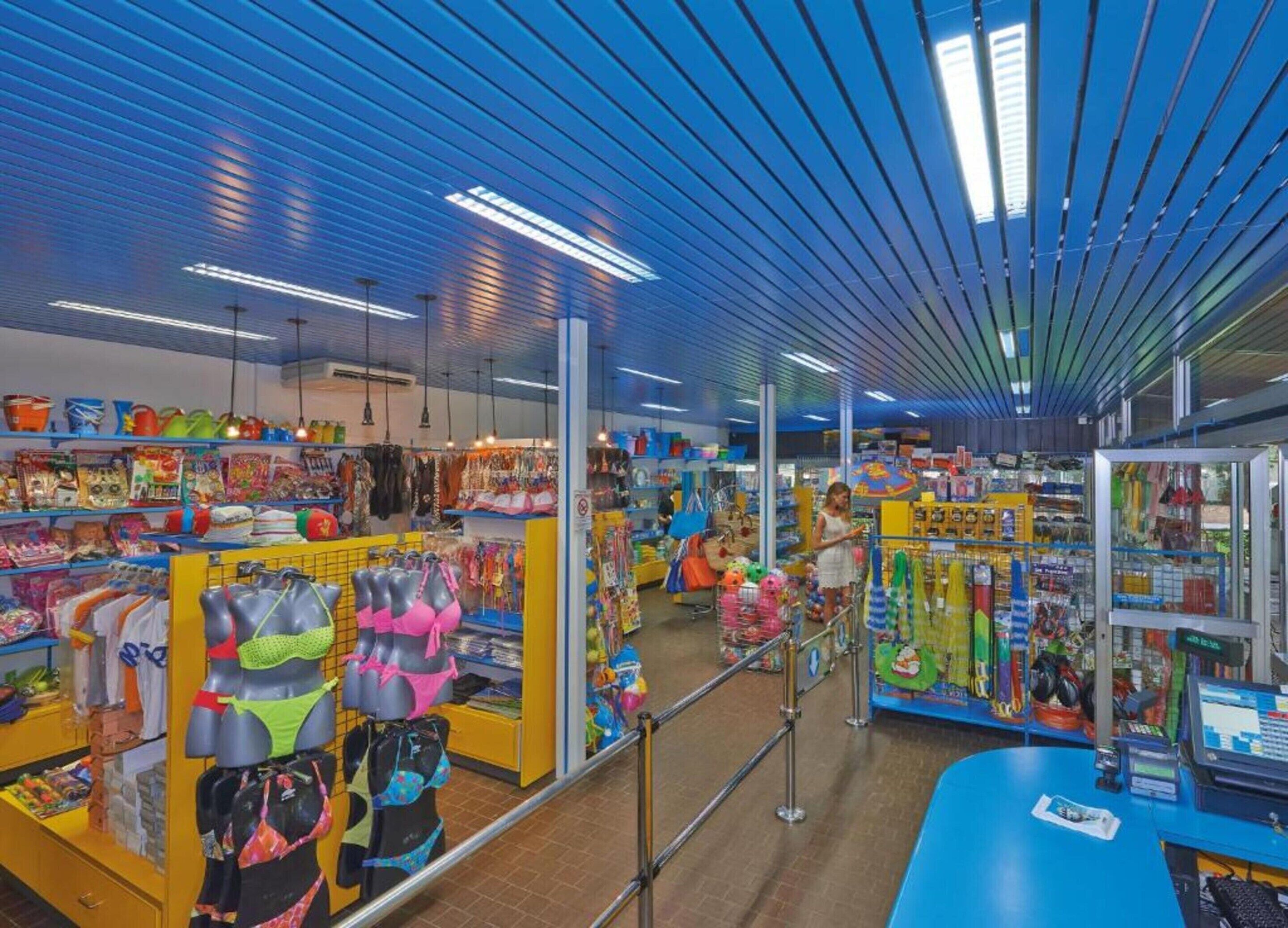 A brightly lit store with various colorful items on shelves and displays, including toys and clothing.