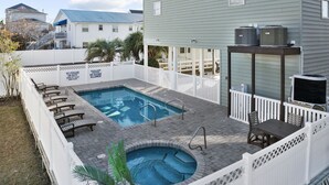 A backyard with a swimming pool, lounge chairs, and an outdoor kitchen area. - Close To Ocean Pet Friendly 6 Bedroom / 5 Bath Private Home with Private Pool (North Myrtle Beach)