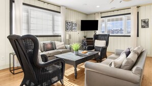 A living room with a sofa, two armchairs, a coffee table, and a ceiling fan. - Close To Ocean Pet Friendly 6 Bedroom / 5 Bath Private Home with Private Pool (North Myrtle Beach)